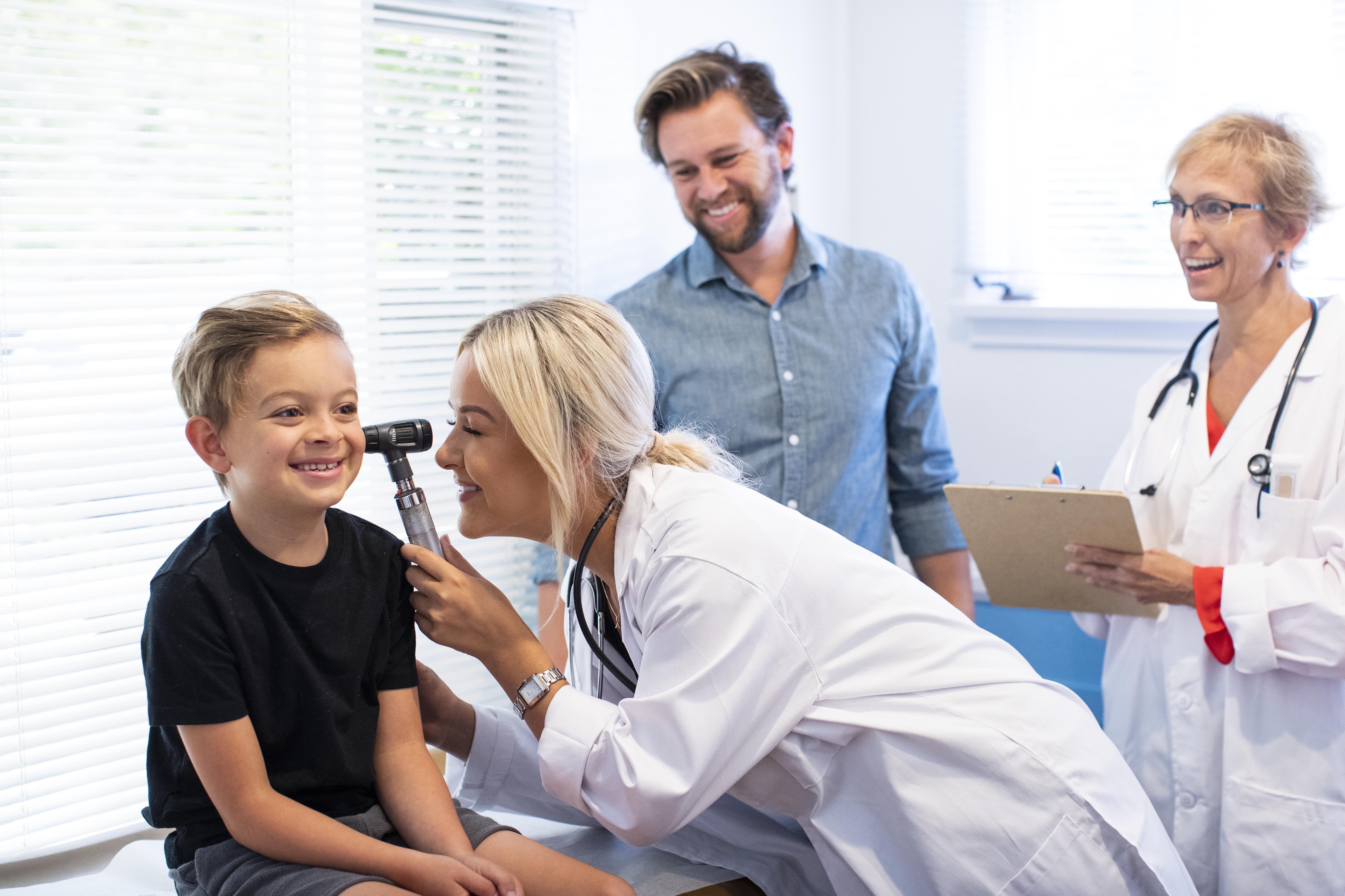 family nurse practitioner with father and son