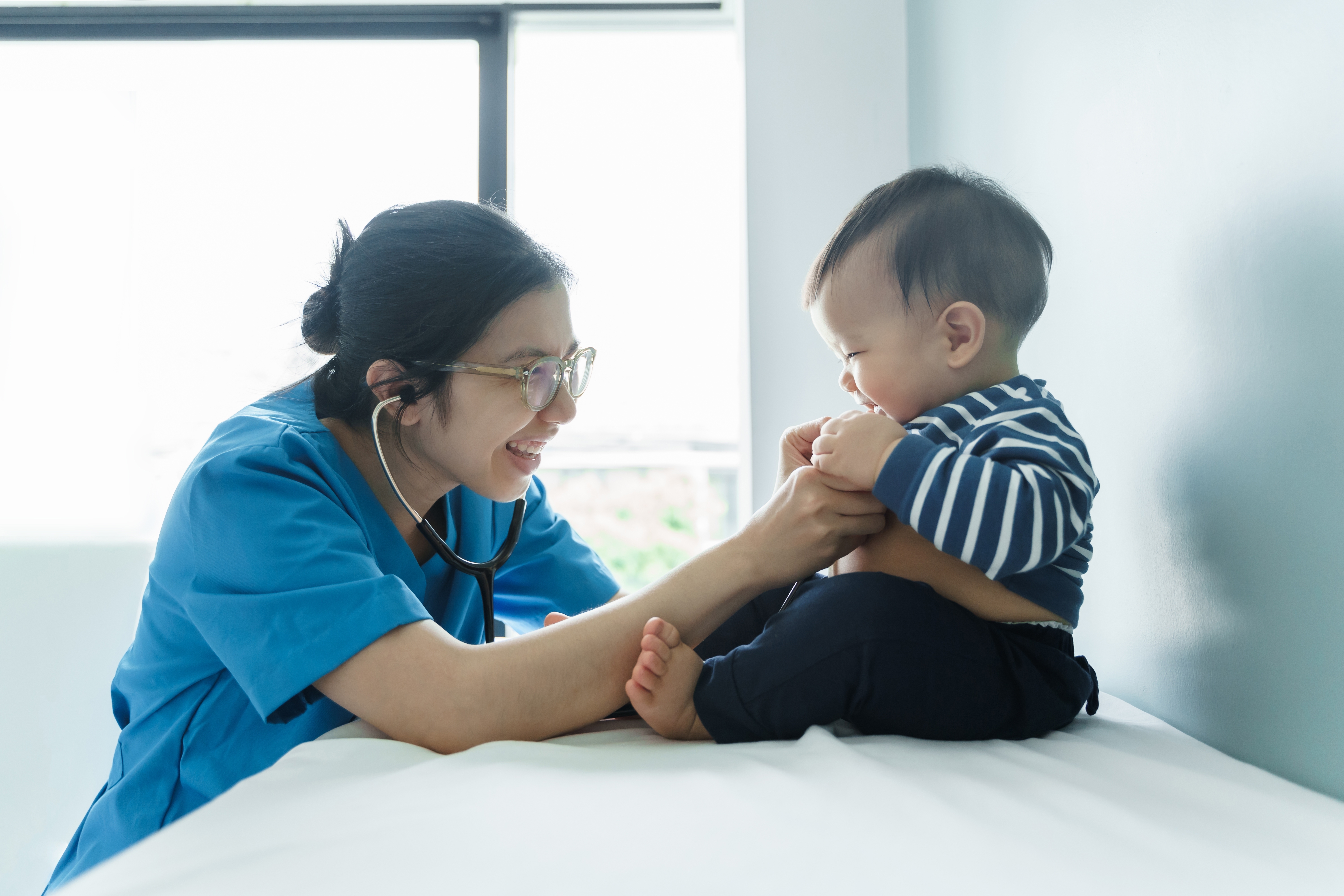 pediatric nurse practitioner with small child