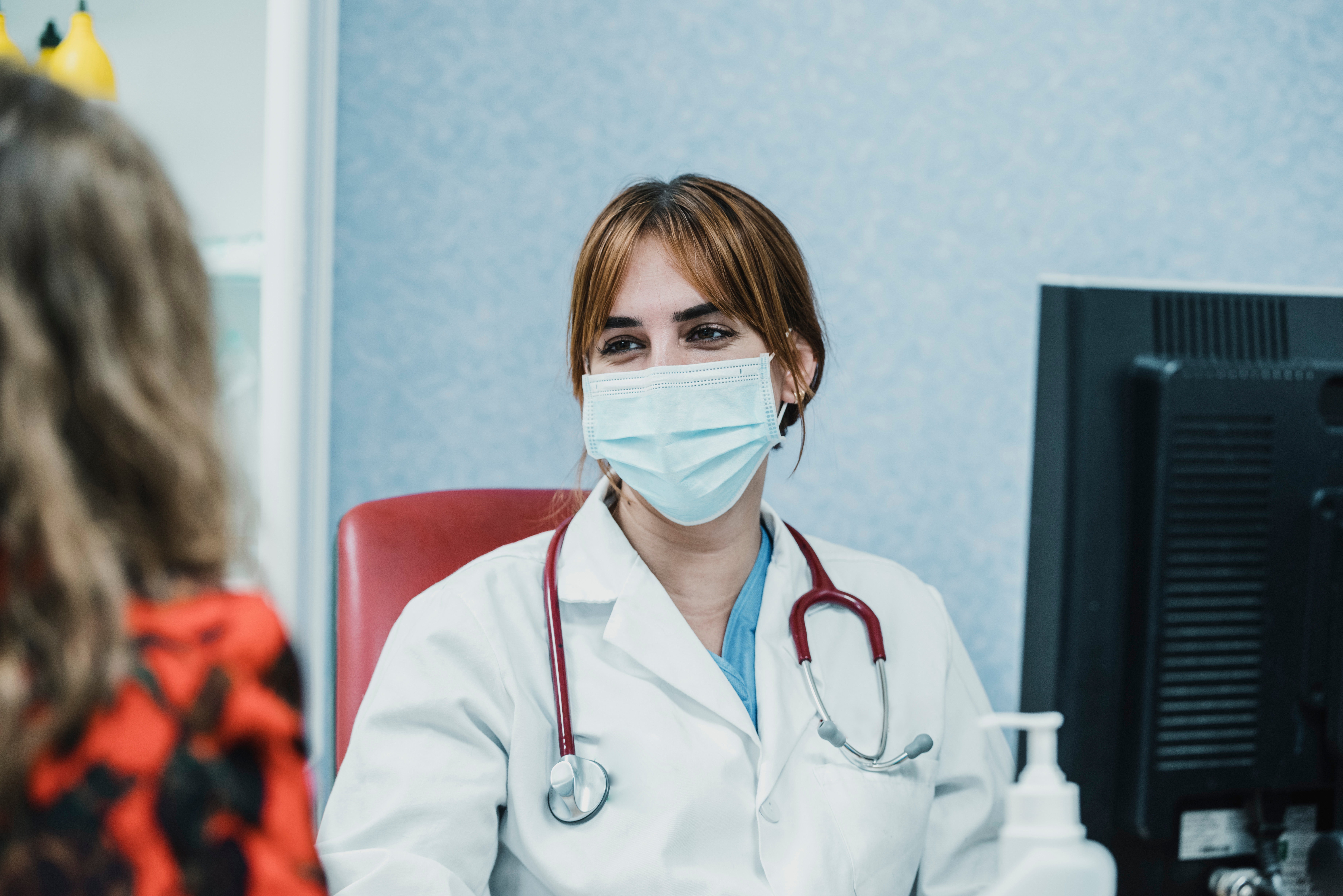 Masked doctor with patient