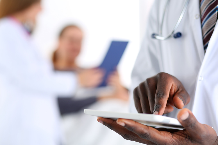 Close-up of a medical professional on a tablet. 