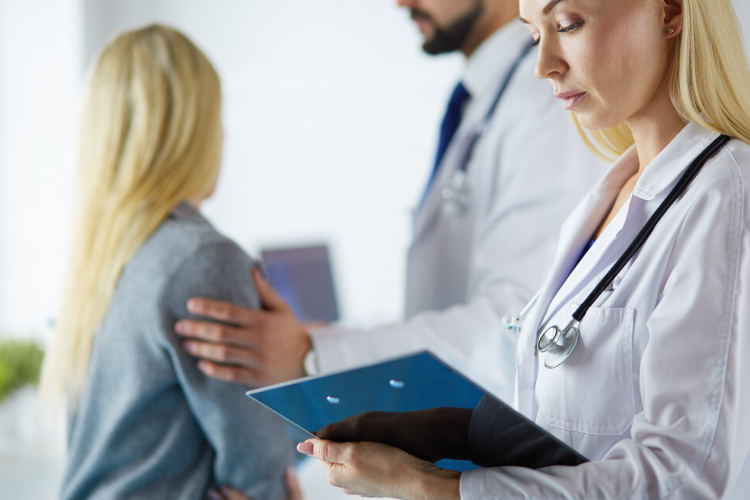 A nurse holding a clipboard. 