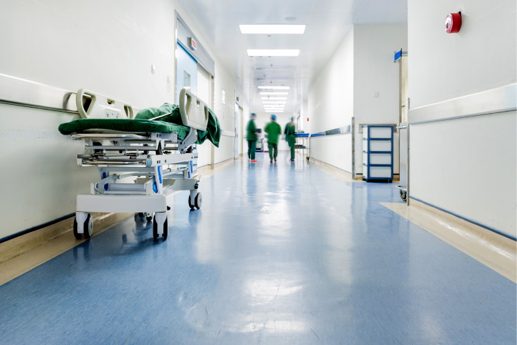 A hospital hallway with a medical cot.