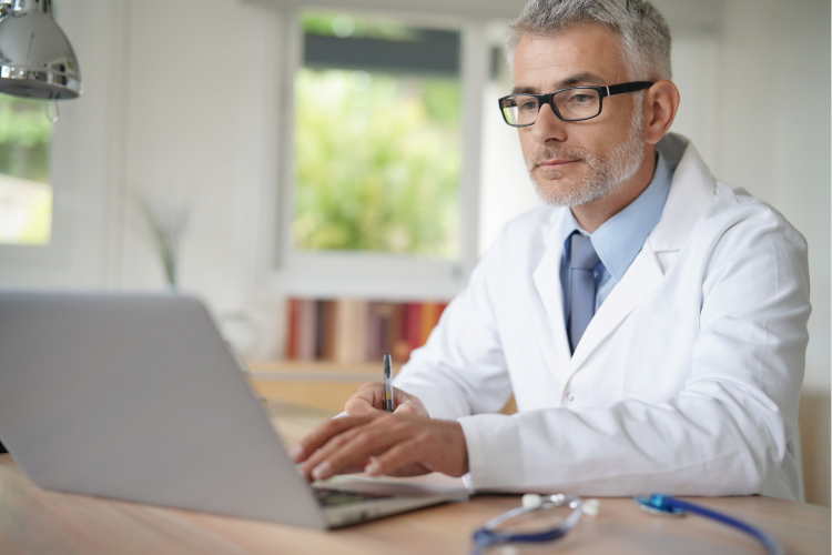 Nurse working on a laptop. 