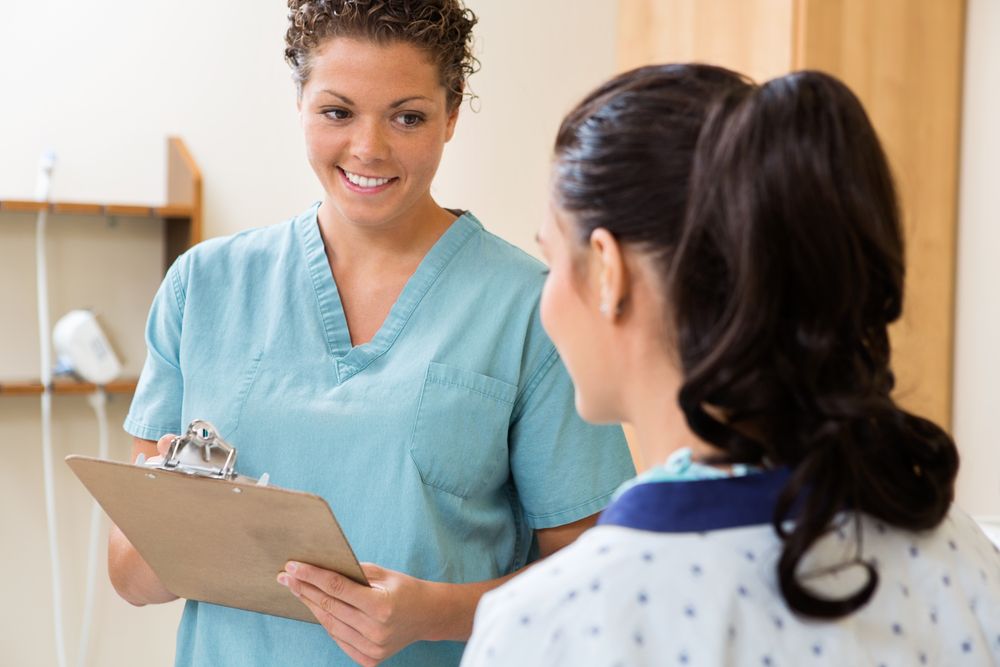 Nurse Educator with Registered Nurse holding clipboard