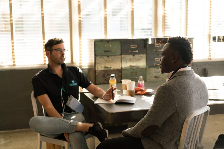 Two school counselors meet to discuss a student.